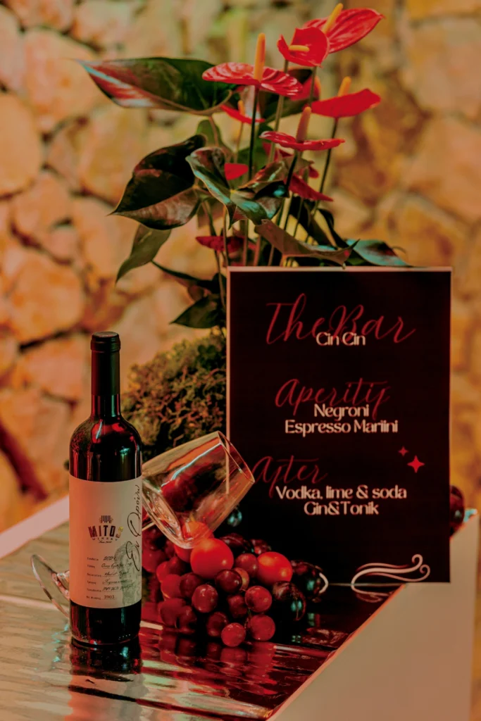 red wine Mitos brand on a designed festive bar stand