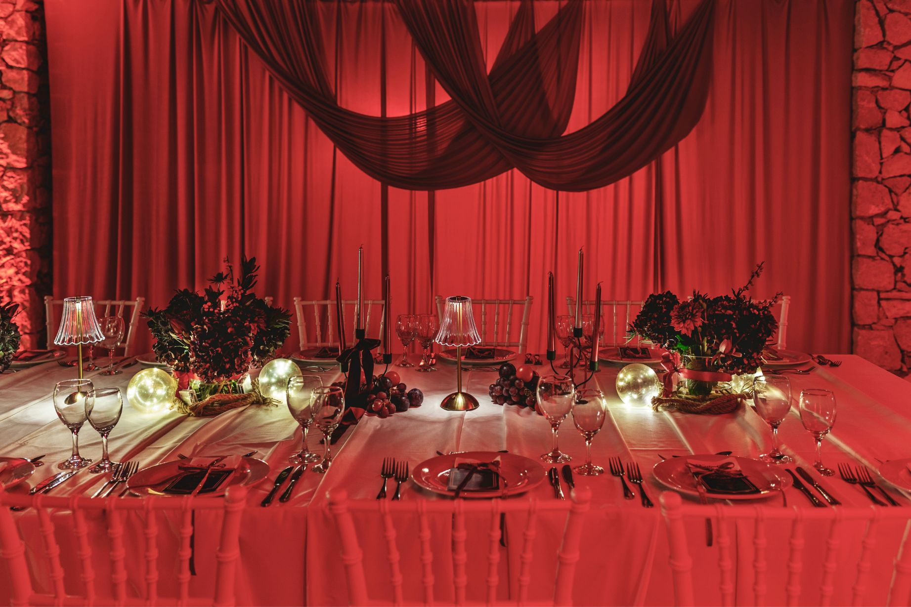luxury festive private dinner styling with candles and red accents
